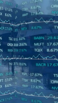 Vertical video: Moored boats in harbor while finance feed starting tickers, charts showing trends