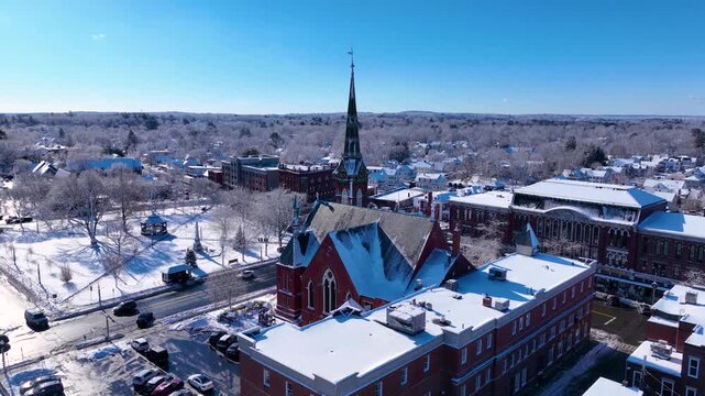 First Congregational Church aerial view in winter with snow at 2 E Central Street in historic town center of Natick, Massachusetts, USA.