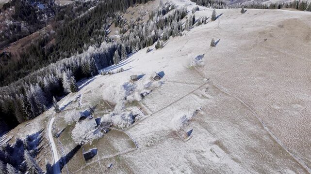 Snowy Alpine Hamlet Dotted With Cabins, Frost Covered Roofs And Yards, Intersecting Fences, Narrow Farm Road, Scattered Cottages And Fenced Pasture, Soft Morning Light And Wide Aerial Perspective.