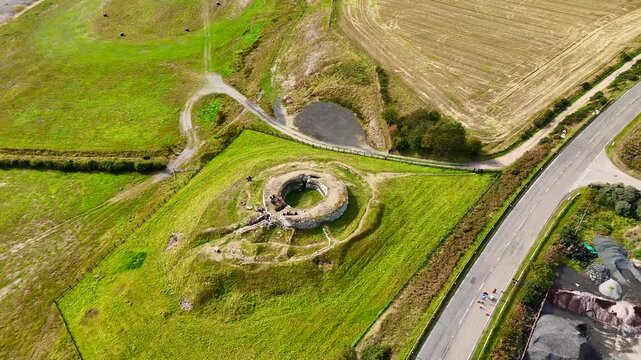 Cinematic Aerial Drone View of Carn Liath Broch, Iron Age Stone Tower in the Scottish Highlands, Ancient Archaeological Site near Sutherland Coast, Scotland, UK