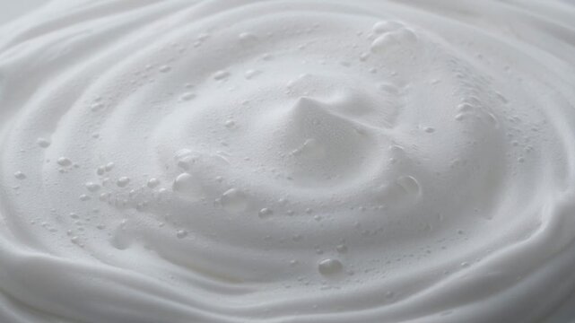 Smooth soap foam cleanser macro texture video with glossy liquid surface, skincare hygiene beauty purity abstract cleansing aesthetic