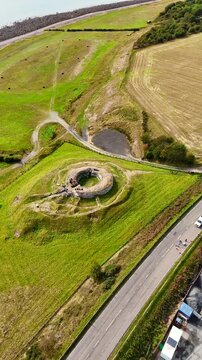 Cinematic Drone Shot of the Ancient Carn Liath Broch Ruins Surrounded by Rugged Scottish Landscape and Green Meadows, North Coast 500 Route, Scotland