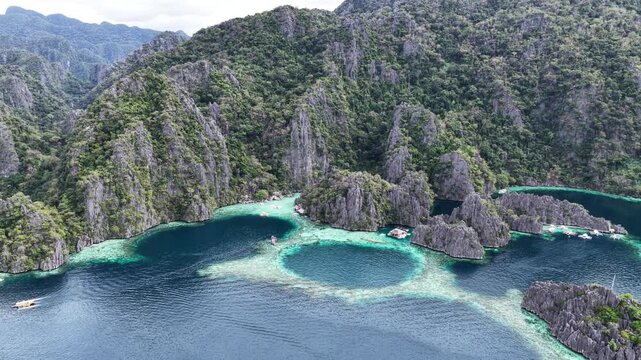 Cinematic drone video of tropical islands of Coron in the Philippines,  with azure blue water and lime stone rock formations