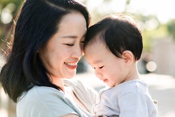 Fototapeta premium A mother lovingly holds her baby, creating a tender moment of connection.