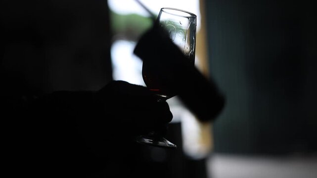 A glass of Oloroso sherry served using a Jerez venencia.