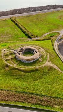 Wide Aerial Pan of the Isolated Carn Liath Broch Stone Ruins, Historical Celtic Settlement in the Wild Grasslands of Northern Scotland, United Kingdom