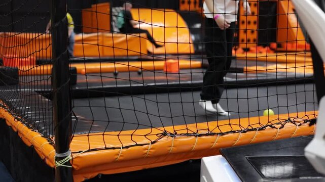 Kids playing on indoor playground in foam rubber pit in trampoline, active pastime in the amusement park. 