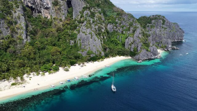 Cinematic drone video of tropical island in the Philippines  with azure blue water and beach
