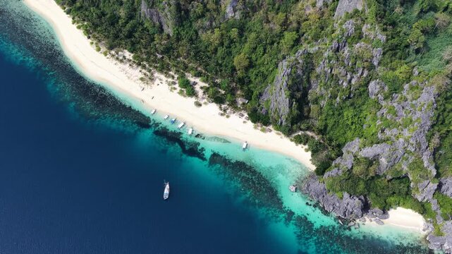 Cinematic drone video of tropical island in the Philippines  with azure blue water and beach