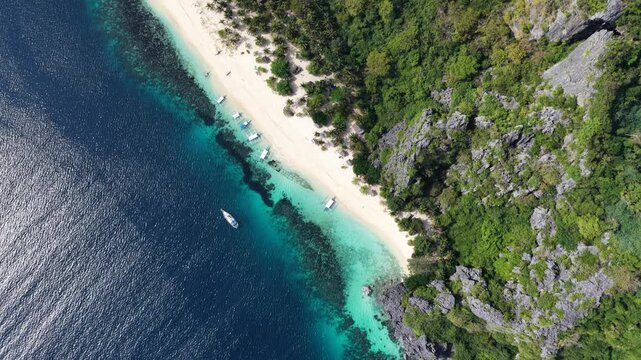 Cinematic drone video of tropical island in the Philippines  with azure blue water and beach