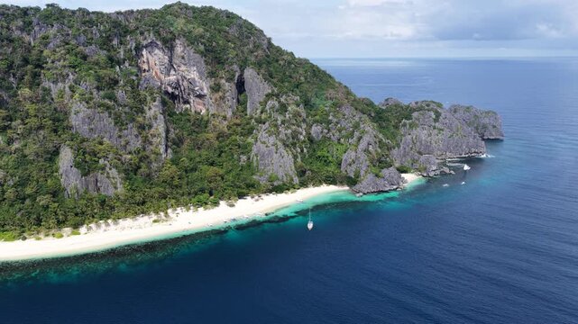Cinematic drone video of tropical island in the Philippines  with azure blue water and beach