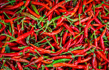 Chiang Mai, Thailand - Red and green spicy chili peppers at fresh market.