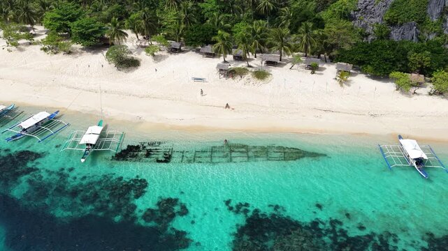 Cinematic drone video of tropical island in the Philippines  with azure blue water and beach