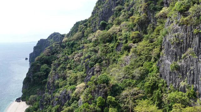 Cinematic drone video of tropical island in the Philippines  with azure blue water and beach