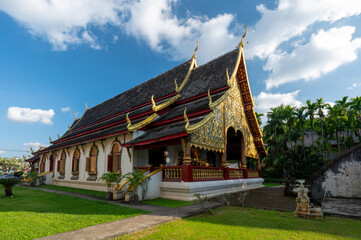 Wat Chiang Man in Chiang Mai Thailand at sunset with its iconic elephant encircled golden stupa and historic Lanna architecture, a must see cultural and travel destination.
