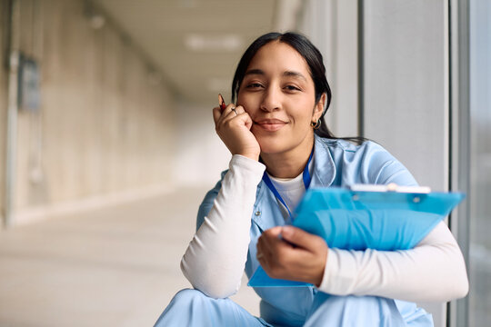Smiling nurse working in a hospital and looking at camera.