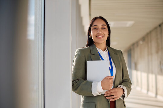 Portrait of happy businesswoman in the office looking at camera.