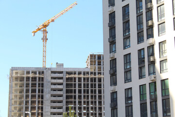 Fototapeta premium construction site with crane, modern building in the city