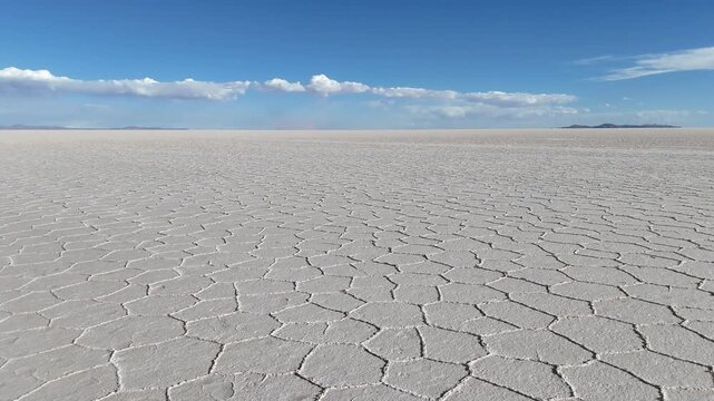 Salar de Uyuni. Endless white landscape and rider on the vast Bolivian salt flats.