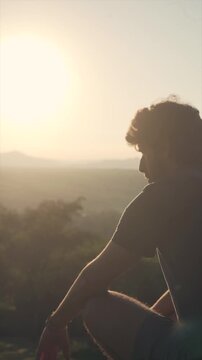 Man in Silhouette Contemplating Nature at Golden Hour Sunset
