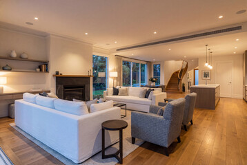 Fototapeta premium Modern luxury living room with white sofas and fireplace