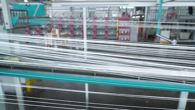 Automated carpet manufacturing machine weaving intricate patterns in a large industrial textile factory
