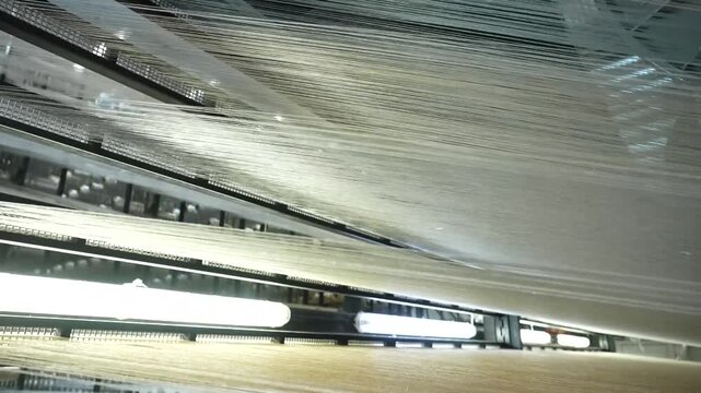 Automated carpet manufacturing machine weaving intricate patterns in a large industrial textile factory