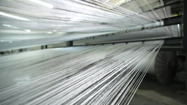 Automated carpet manufacturing machine weaving intricate patterns in a large industrial textile factory