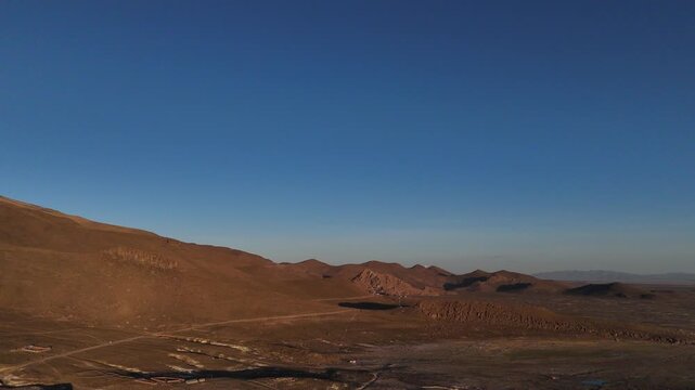 Dramatic sunset over the Altiplano in Huachacalla, Bolivia. Burning orange sky over the high plateau and rural landscape.