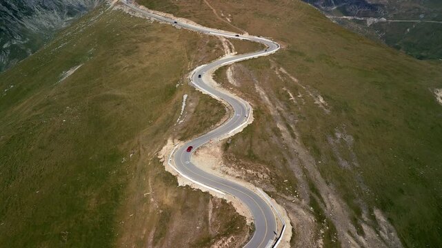 Aerial forward flight over Transalpina mountain road, scenic S-curve highway in Romania