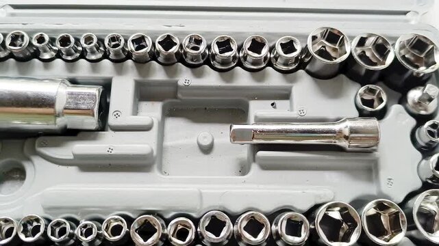 Metal socket wrench tool set in plastic case isolated on white background