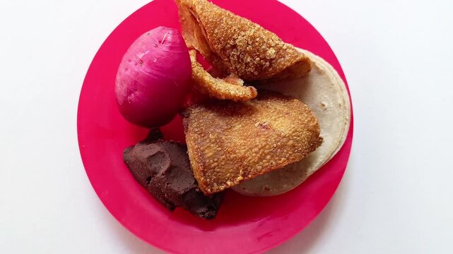 Traditional Guatemalan food chicharron with fried beans radish and tortilla isolated on white background