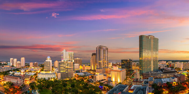Coastal cityscape of St Petersburg, Florida, USA. Illuminated downtown area with modern architecture and scenic views of urban infrastructure in evening.