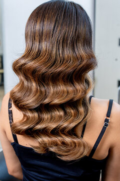 Woman showing beautiful brown hair with finger waves