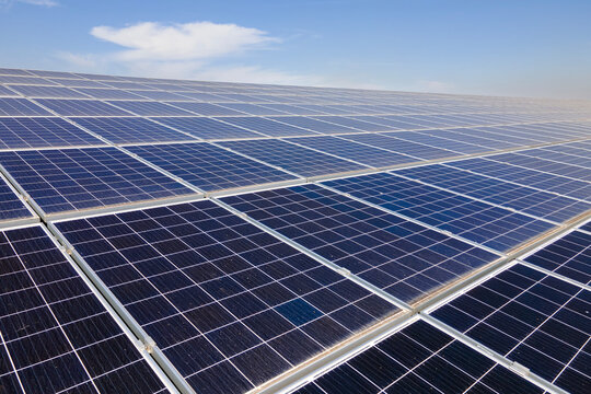 Photovoltaic panels for producing clean ecological electric energy. Commercial building with solar roof. Renewable electricity with zero emission concept