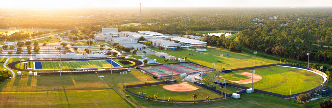 Public high school open air sports facilities in North Port, Florida. American football stadium, tennis courts and baseball diamond sport infrastructure