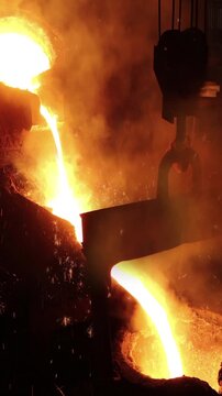 Liquid metal in the foundry, melting iron in furnace, steel mill. Smelting is a process of applying heat to ore in order to extract a base metal