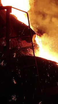 Liquid metal in the foundry, melting iron in furnace, steel mill. Smelting is a process of applying heat to ore in order to extract a base metal