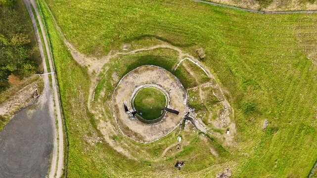 Cinematic Drone Shot of the Ancient Carn Liath Broch Ruins Surrounded by Rugged Scottish Landscape and Green Meadows, North Coast 500 Route, Scotland

