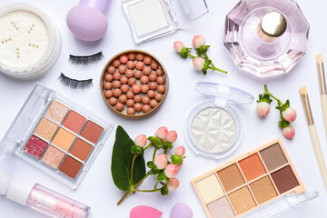 Spring composition with different makeup products and flowers on white background, flat lay