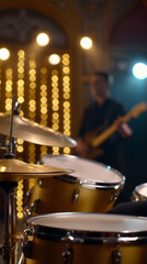 Obraz premium Drum set on stage with blurred musician and festive lights in background during live music performance.