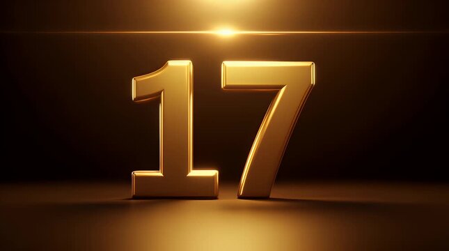 Spectacular three dimensional golden number seventeen illuminated against a dark background creating a prestigious and celebratory visual effect