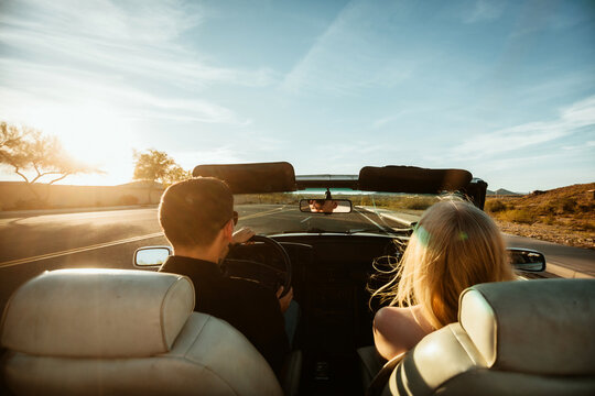 Couple driving in convertible