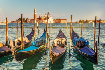 Moored Gondolas late afternoon, with the Basilica San Giorgio Maggiore in the background, across the lagoon, in Venice, Italy © mandritoiu