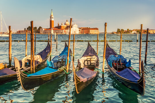Moored Gondolas late afternoon, with the Basilica San Giorgio Maggiore in the background, across the lagoon, in Venice, Italy