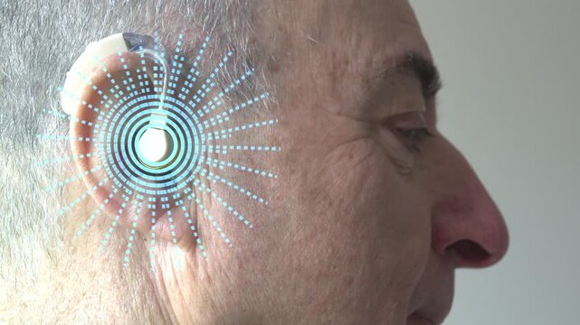 Man with hearing aid listens. visualization of sounds using computer graphics