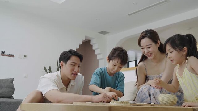 Family enjoying a game of Go in the hotel room