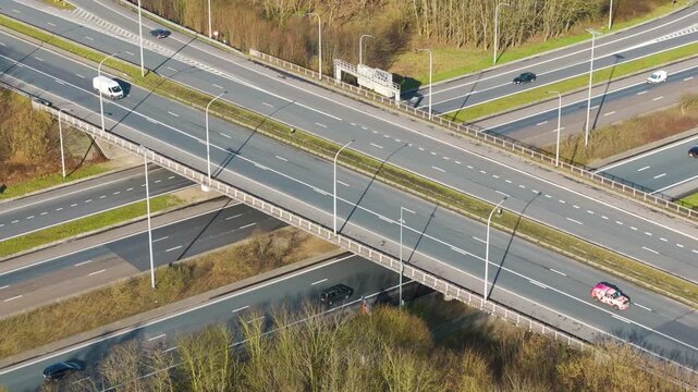 motorway bridge ghent light traffic crossing layered highway infrastructure green roadside landscape overhead near aerial drone view transport transportation vehicle travel 