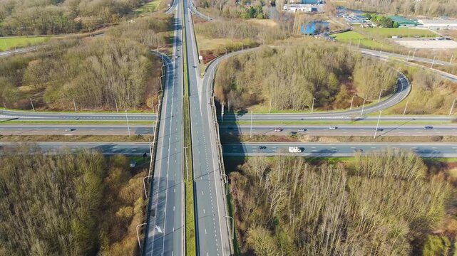centered perspective motorway running north south ghent dual lanes slip roads flat flemish countryside landscape near aerial drone highway traffic transport infrastructure transportation 