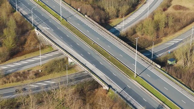 high motorway bridge merging slip roads ghent light traffic green roadside landscape near angle aerial drone view highway transport infrastructure transportation junction interchange 